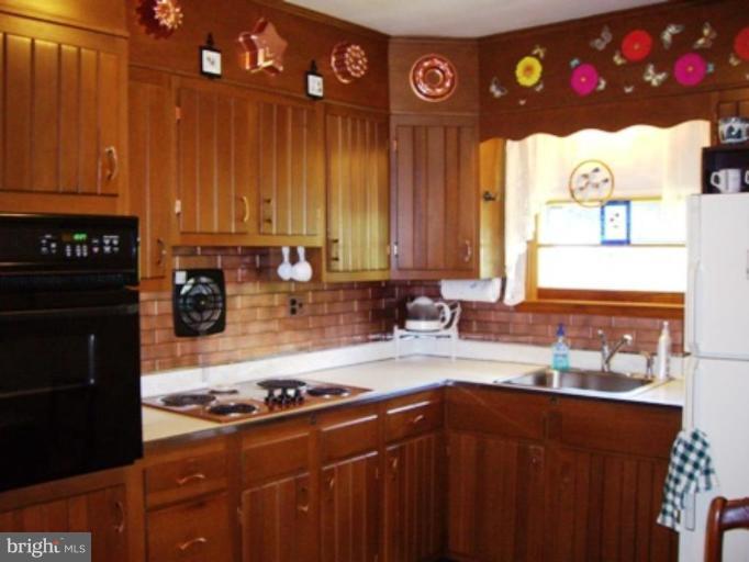 1317 Murgatroyd Road Fallston, MD 21047 - Photo 10 of 17 a kitchen with a stove a sink and a cabinets