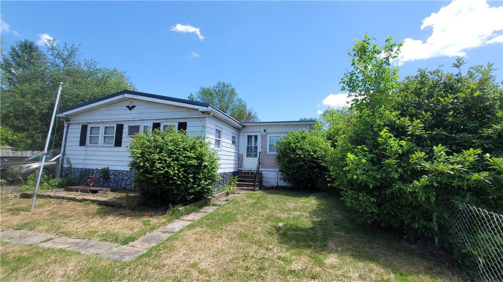 225 Lowber Road Fayette City, PA 15438 - Photo 2 of 29 a front view of a house with a yard and potted plants