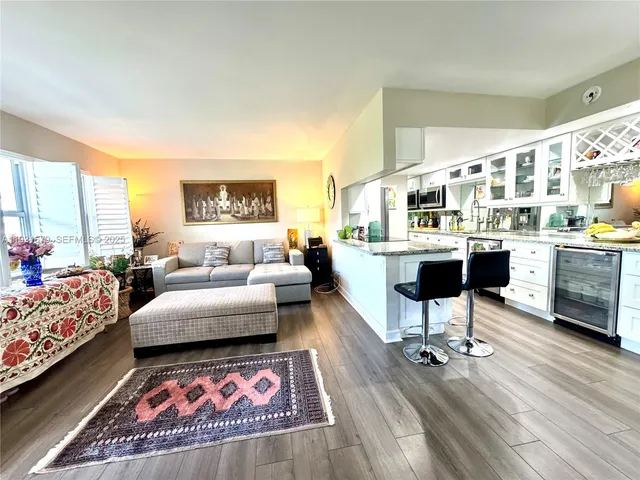 a living room with furniture a rug and a table