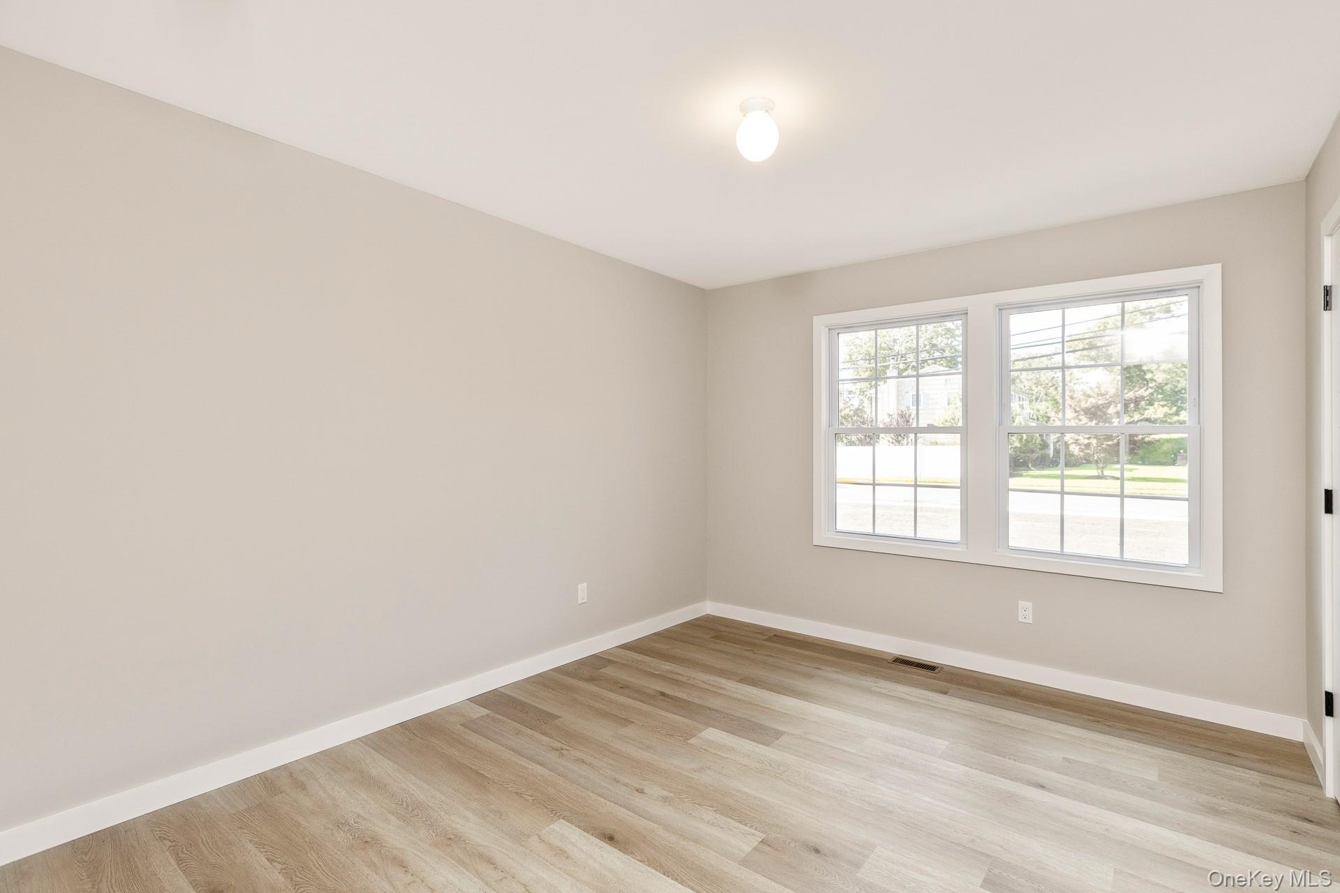 92 Park Street Blue Point, NY 11715 - Photo 13 of 32 Spare room with baseboards and light wood-style floors