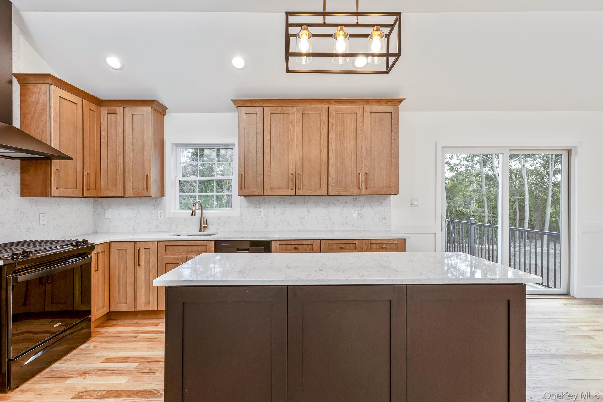 92 Park Street Blue Point, NY 11715 - Photo 24 of 32 Kitchen with black range oven, wall chimney exhaust hood, recessed lighting, tasteful backsplash, and light stone counters