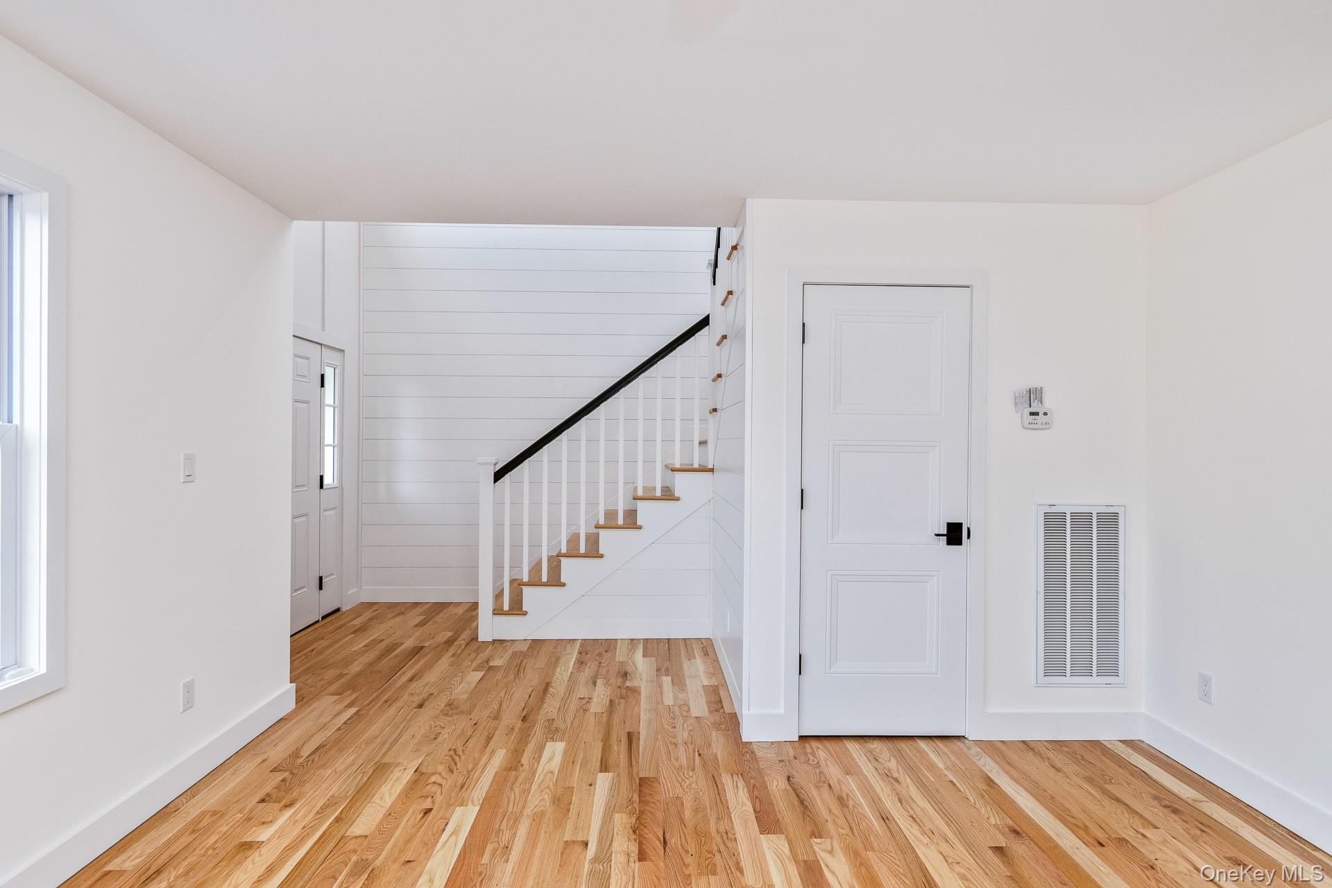 92 Park Street Blue Point, NY 11715 - Photo 7 of 32 Entrance foyer featuring stairs and light wood-style flooring