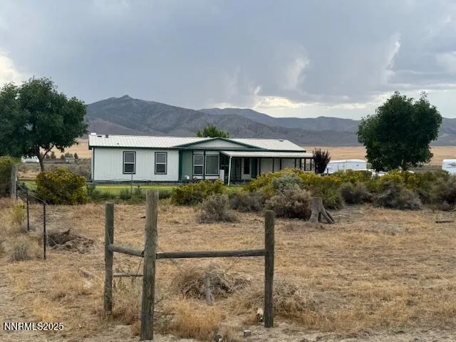 a view of a house with a yard and plants