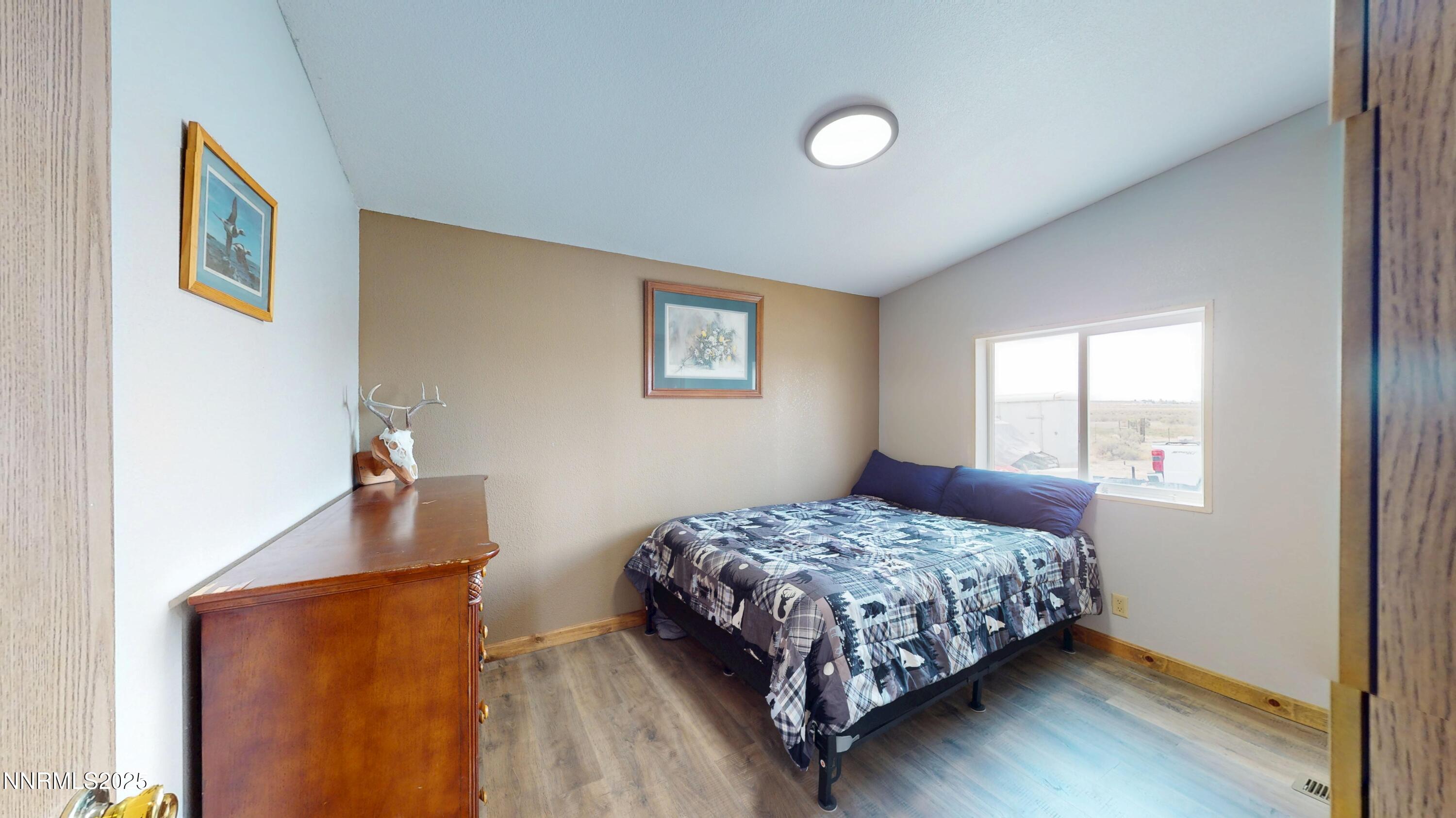 8425 Styles Court Winnemucca, NV 89445 - Photo 14 of 27 a bedroom with a bed and wooden floor