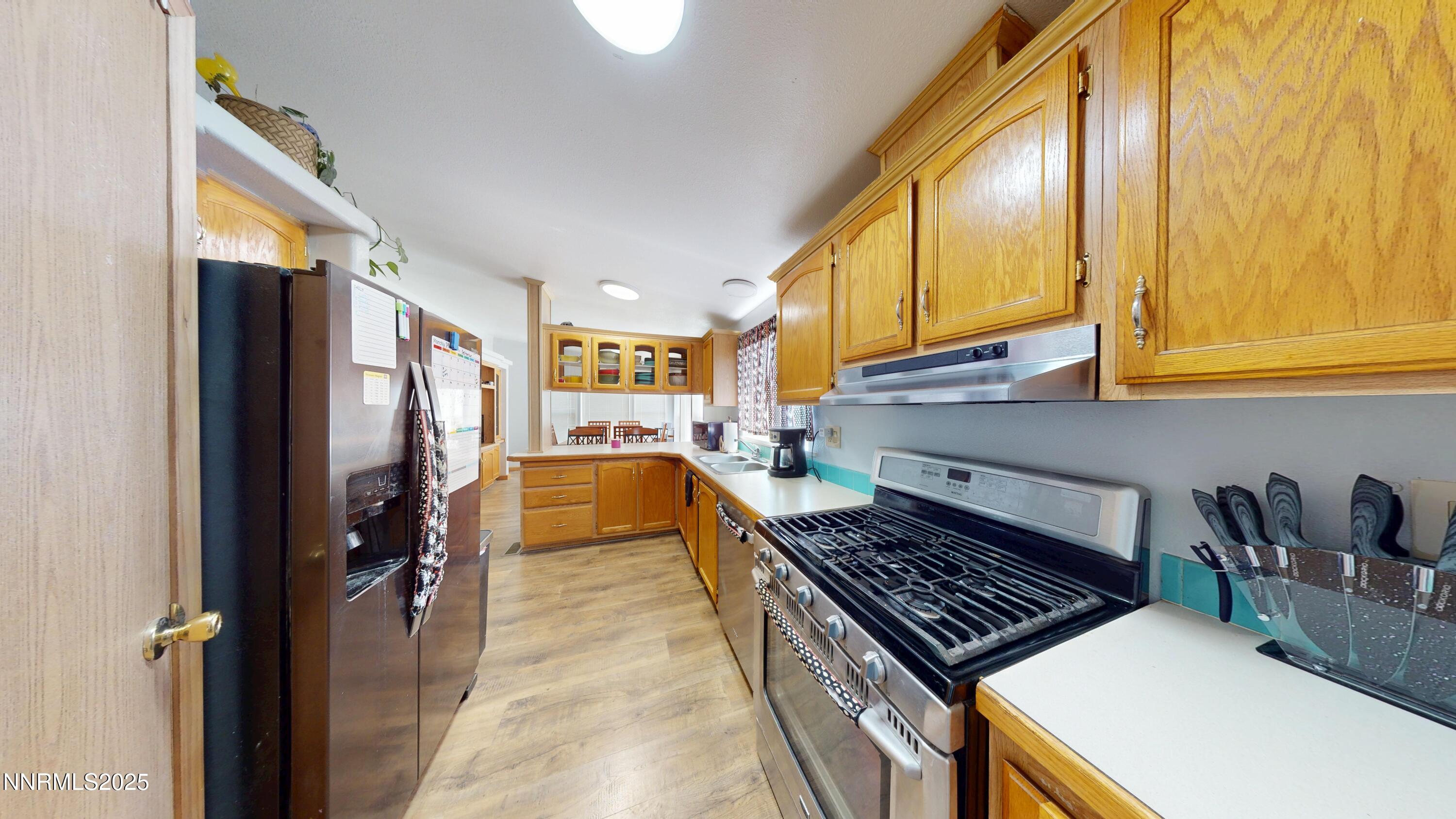 8425 Styles Court Winnemucca, NV 89445 - Photo 6 of 27 a kitchen with sink refrigerator and stove