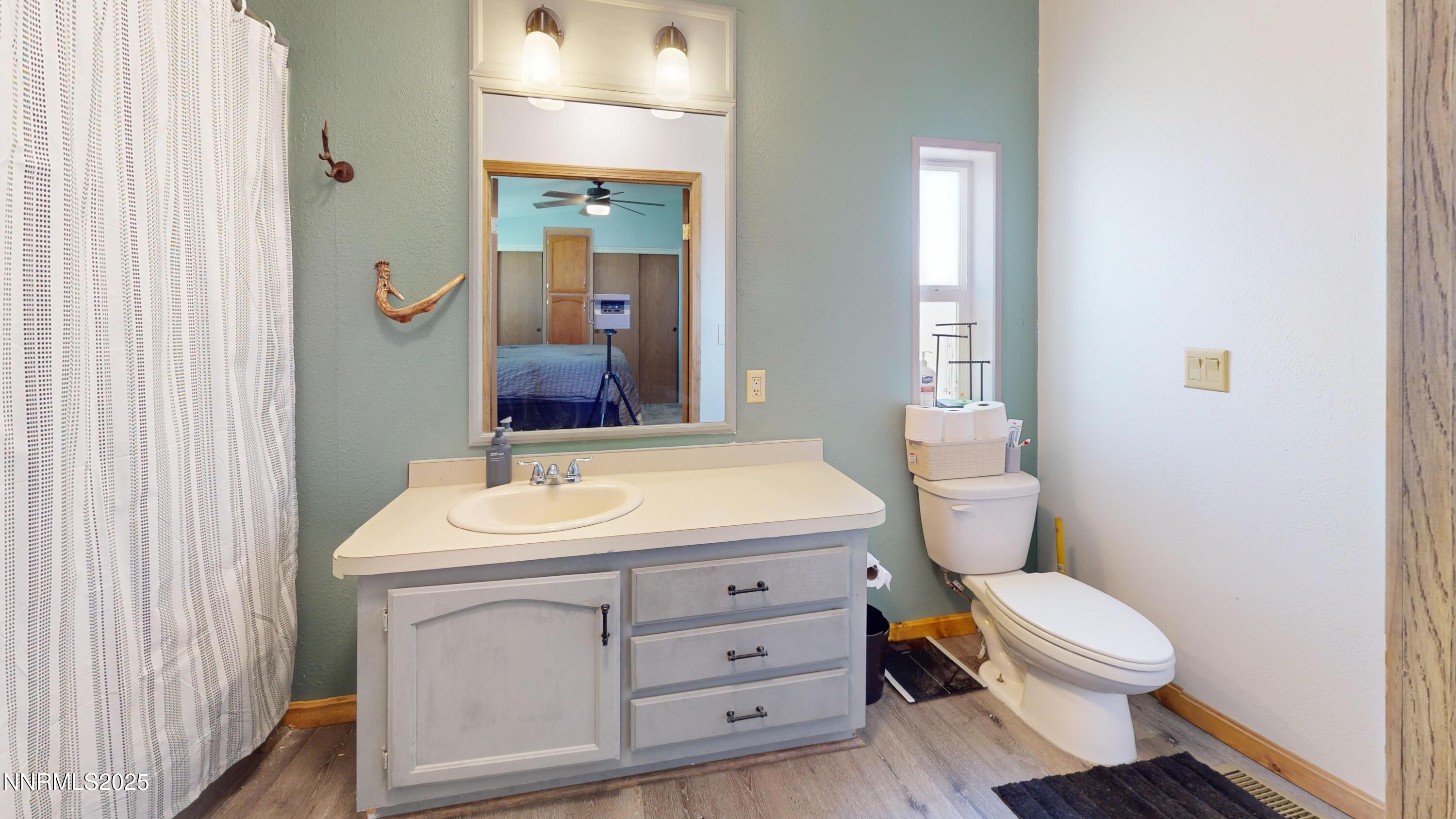 8425 Styles Court Winnemucca, NV 89445 - Photo 10 of 27 a bathroom with a toilet a sink and mirror