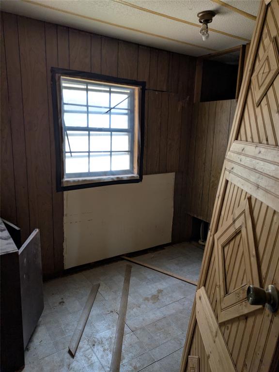 402 Marion Street Merkel, TX 79536 - Photo 13 of 23 a view of an empty room with wooden floor and stairs