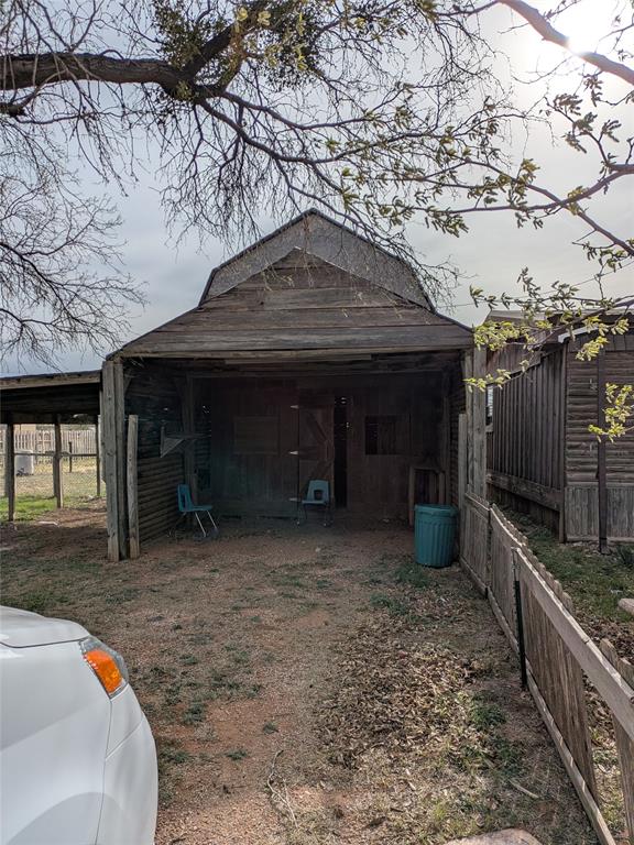 402 Marion Street Merkel, TX 79536 - Photo 18 of 23 a front view of a house with a yard and garage