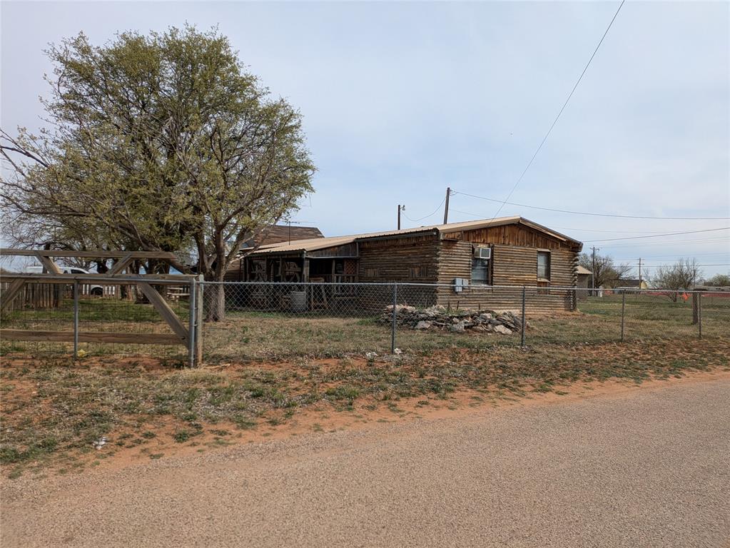 402 Marion Street Merkel, TX 79536 - Photo 6 of 23 a front view of a house with a yard