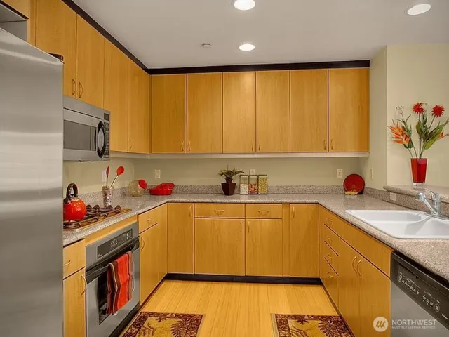 a kitchen with a sink a stove and cabinets