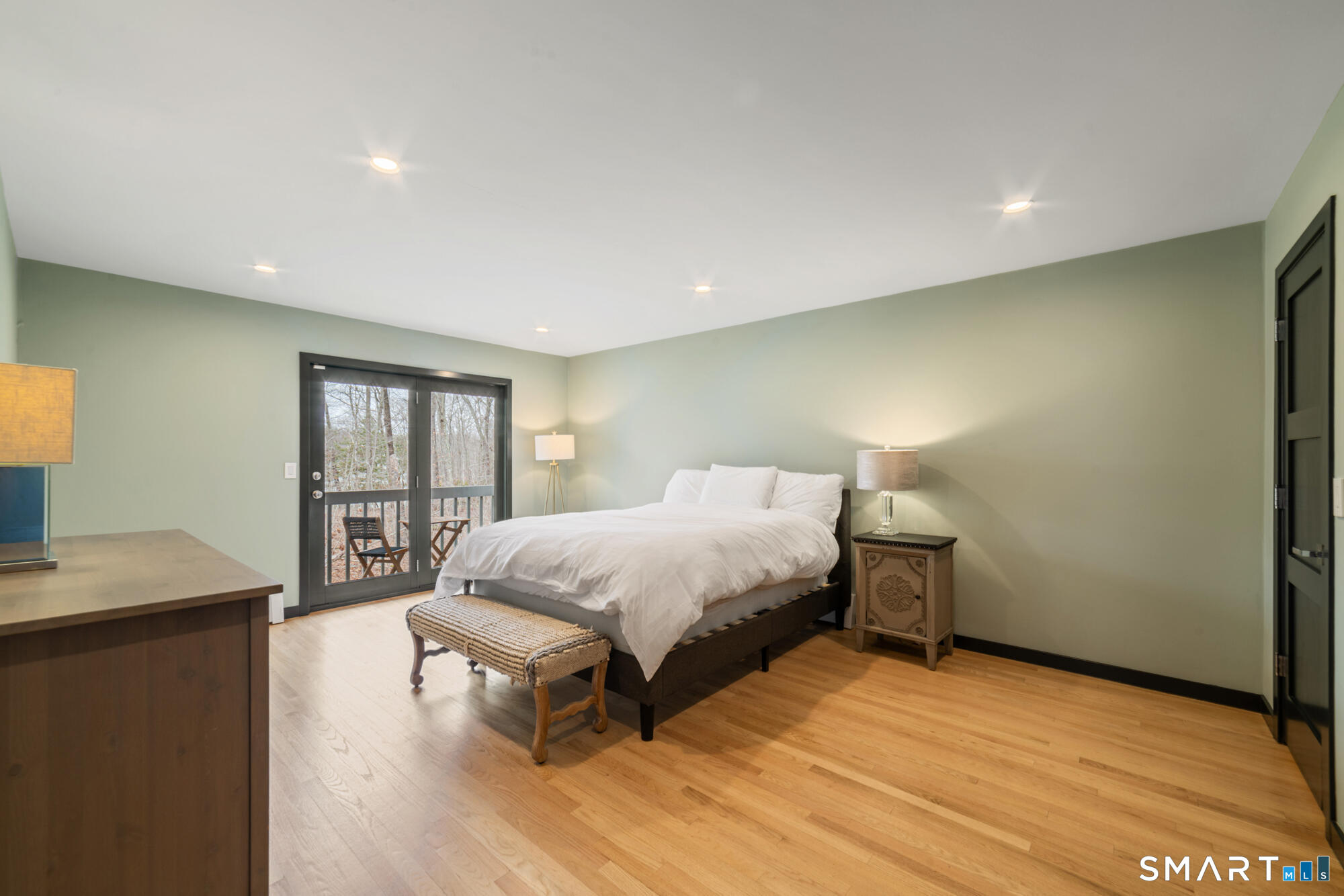 14 Fox Ridge Guilford, CT 06437 - Photo 26 of 39 a spacious bedroom with a bed a table and painting on the wall