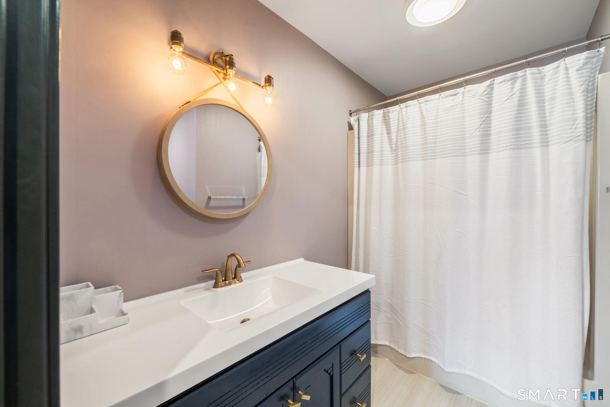 14 Fox Ridge Guilford, CT 06437 - Photo 27 of 39 a bathroom with a sink a mirror and a shower curtain