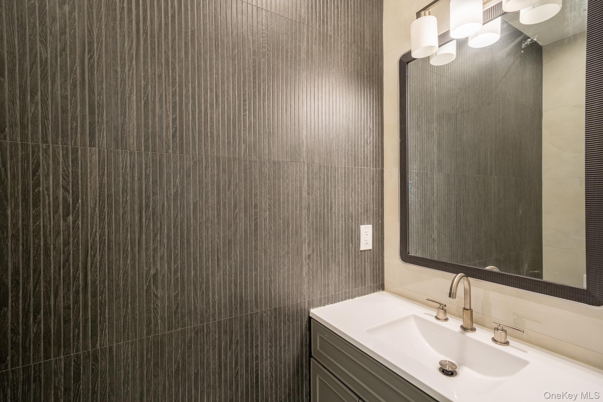 770 Cedar Street Syosset, NY 11791 - Photo 16 of 35 Bathroom featuring vanity and tile walls
