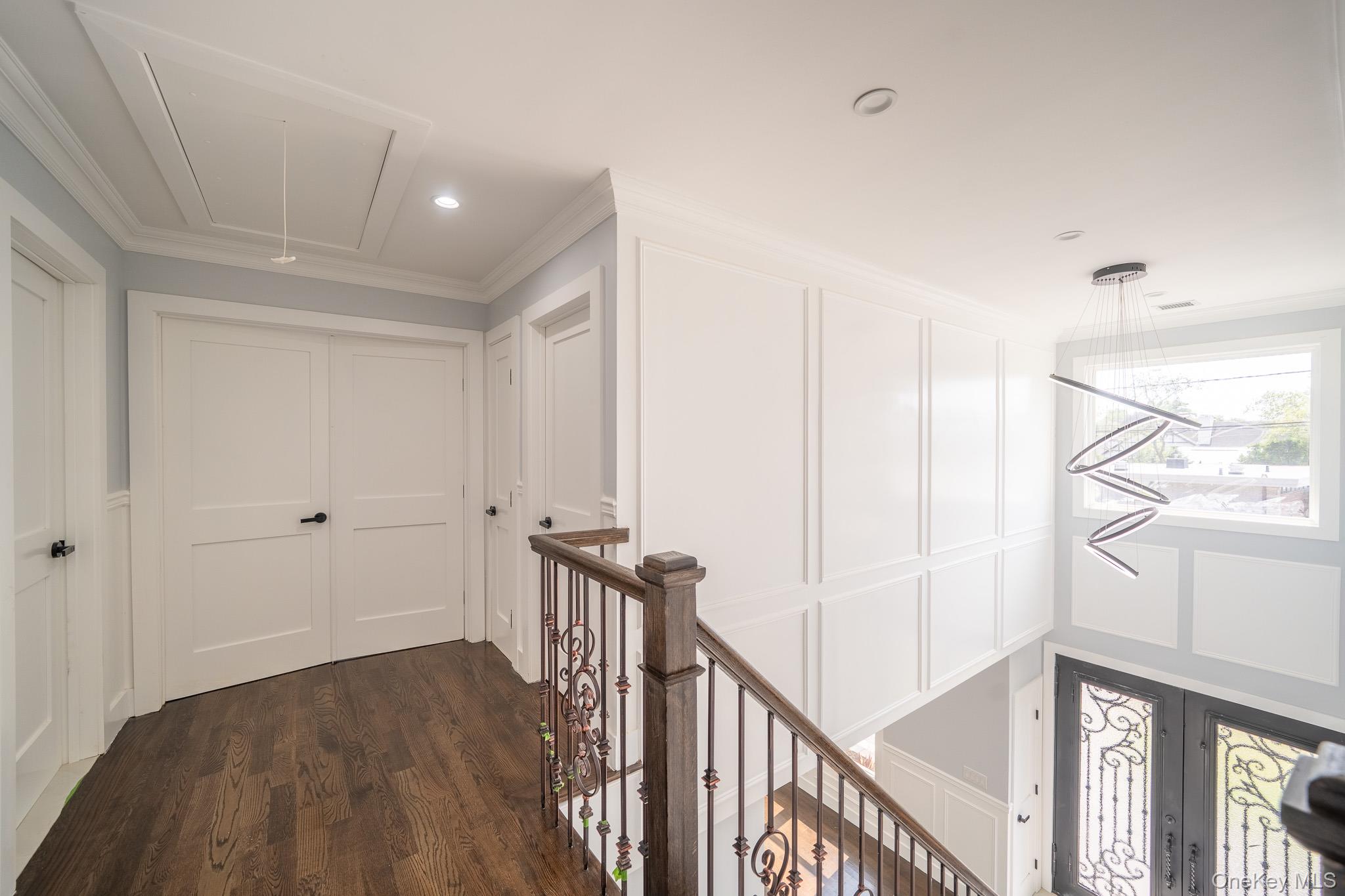 770 Cedar Street Syosset, NY 11791 - Photo 21 of 35 Corridor with attic access, a decorative wall, dark wood-style flooring, recessed lighting, and ornamental molding