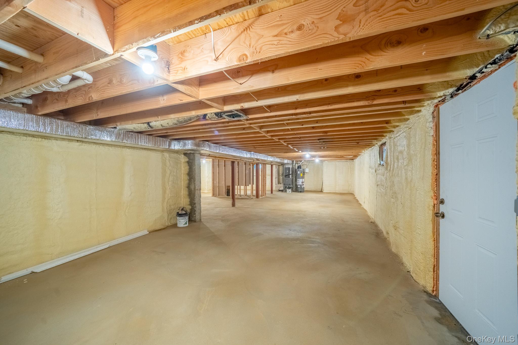 770 Cedar Street Syosset, NY 11791 - Photo 33 of 35 Unfinished below grade area featuring gas water heater