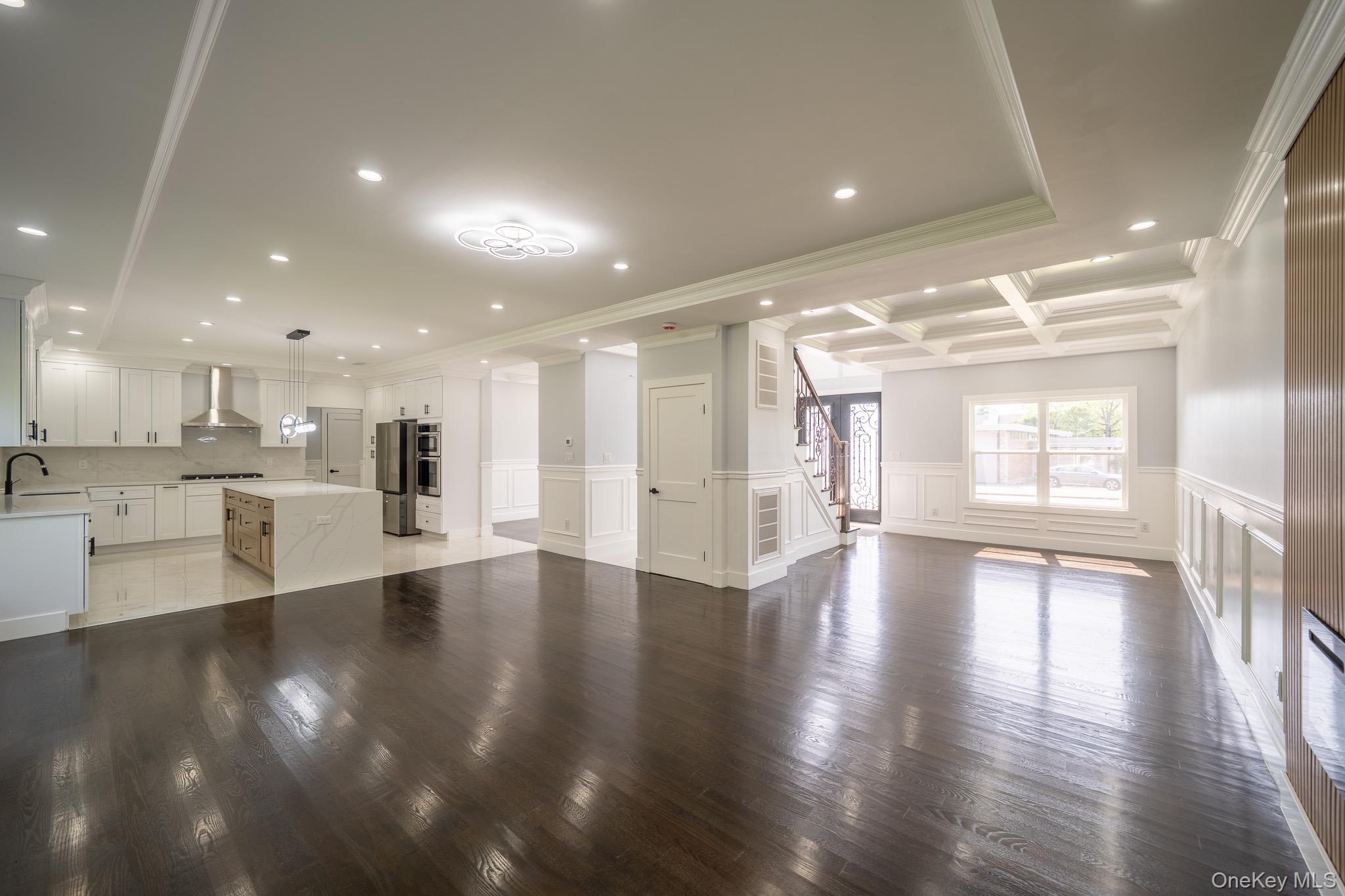 770 Cedar Street Syosset, NY 11791 - Photo 9 of 35 Unfurnished living room with recessed lighting, a decorative wall, wainscoting, coffered ceiling, and crown molding