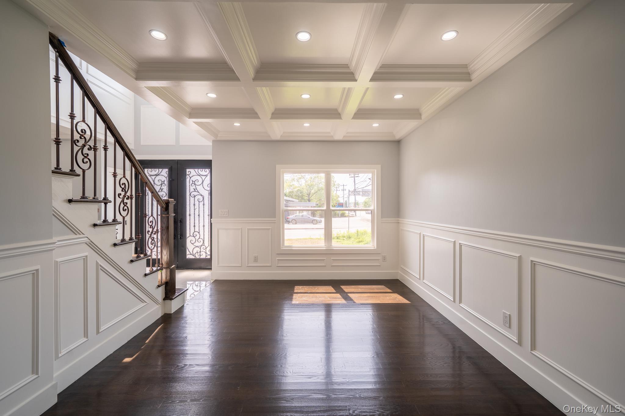 770 Cedar Street Syosset, NY 11791 - Photo 10 of 35 Entrance foyer featuring crown molding, beam ceiling, stairs, coffered ceiling, and dark wood-style flooring