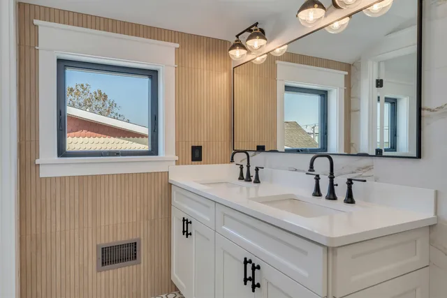 a bathroom with a granite countertop shower and a toilet