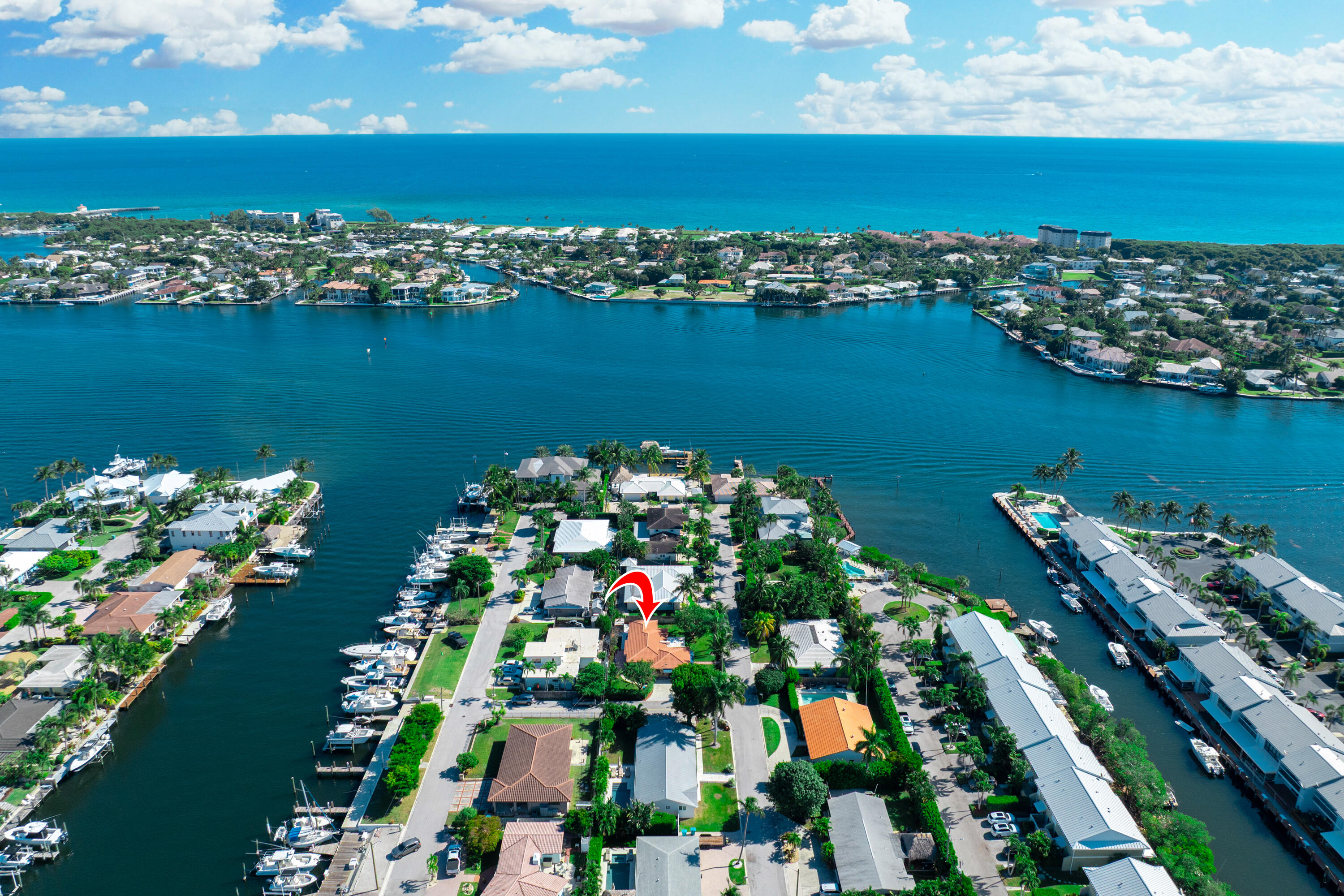 an aerial view of water body with boats and residential houses with outdoor space