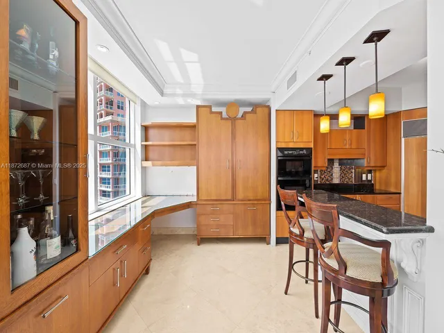 a living room with furniture and large windows