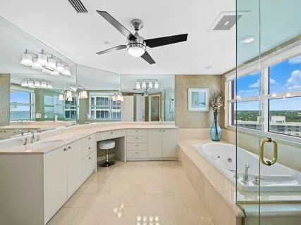 a bathroom with a granite countertop sink a toilet and shower