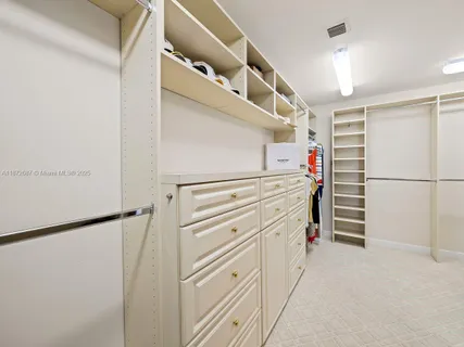 a view of walk in closet with white walls