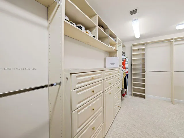 a view of walk in closet with white walls