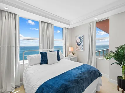 a bedroom with a bed dresser and a large mirror