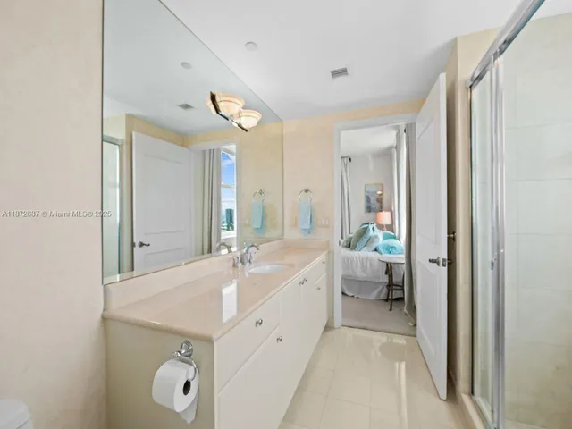 a bathroom with a glass shower door