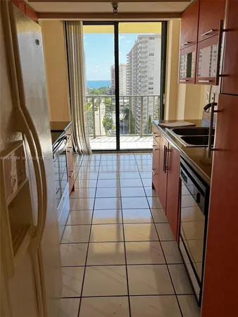 a kitchen with stainless steel appliances granite countertop a refrigerator a sink and a large window