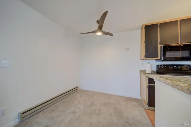 a view of kitchen with stainless steel appliances a refrigerator and a stove