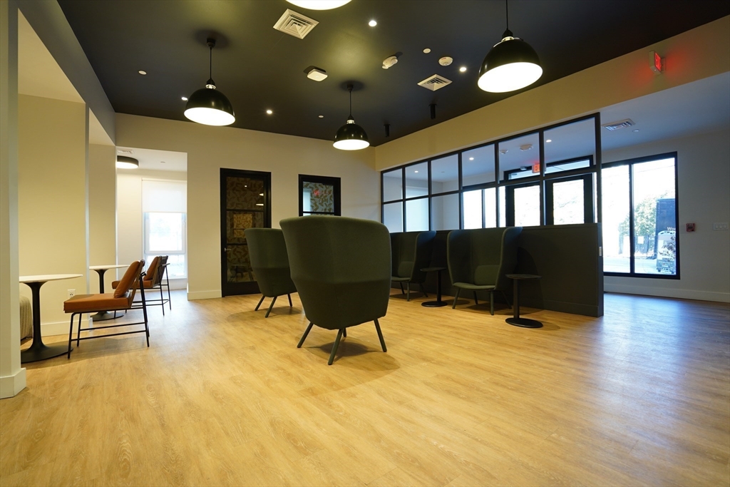 289 Walk Hill Street, Unit 327 Boston, MA 02131 - Photo 13 of 31 a living room with furniture and a large window