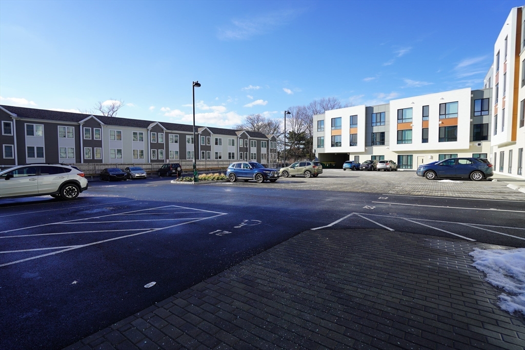 289 Walk Hill Street, Unit 327 Boston, MA 02131 - Photo 18 of 31 a car parked on the side of a street