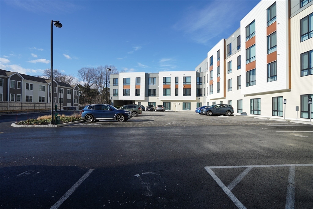 289 Walk Hill Street, Unit 327 Boston, MA 02131 - Photo 19 of 31 a city street lined with buildings and cars