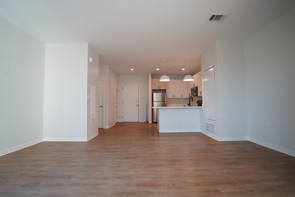 289 Walk Hill Street, Unit 327 Boston, MA 02131 - Photo 21 of 31 a view of kitchen with kitchen island and stainless steel appliances