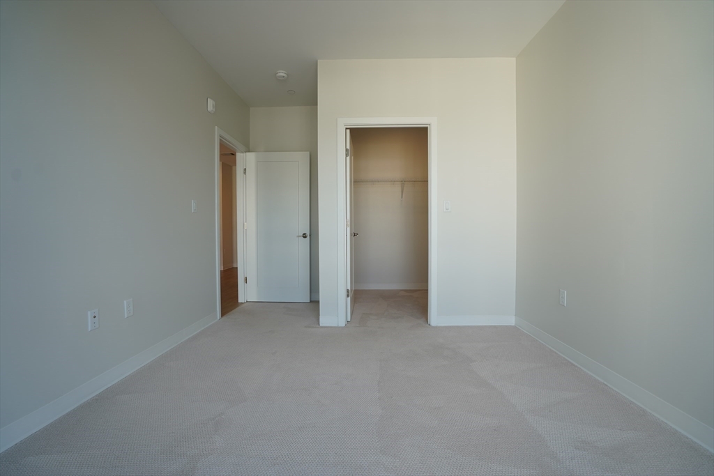 289 Walk Hill Street, Unit 327 Boston, MA 02131 - Photo 29 of 31 a view of an empty room and closet area