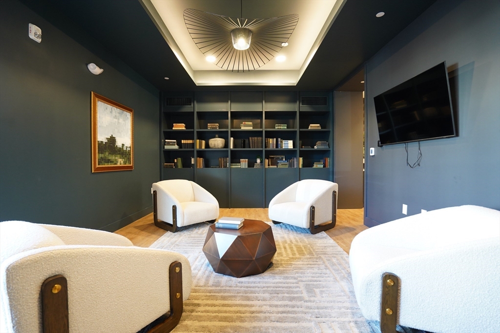 289 Walk Hill Street, Unit 327 Boston, MA 02131 - Photo 3 of 31 a bedroom with two beds and a flat screen tv