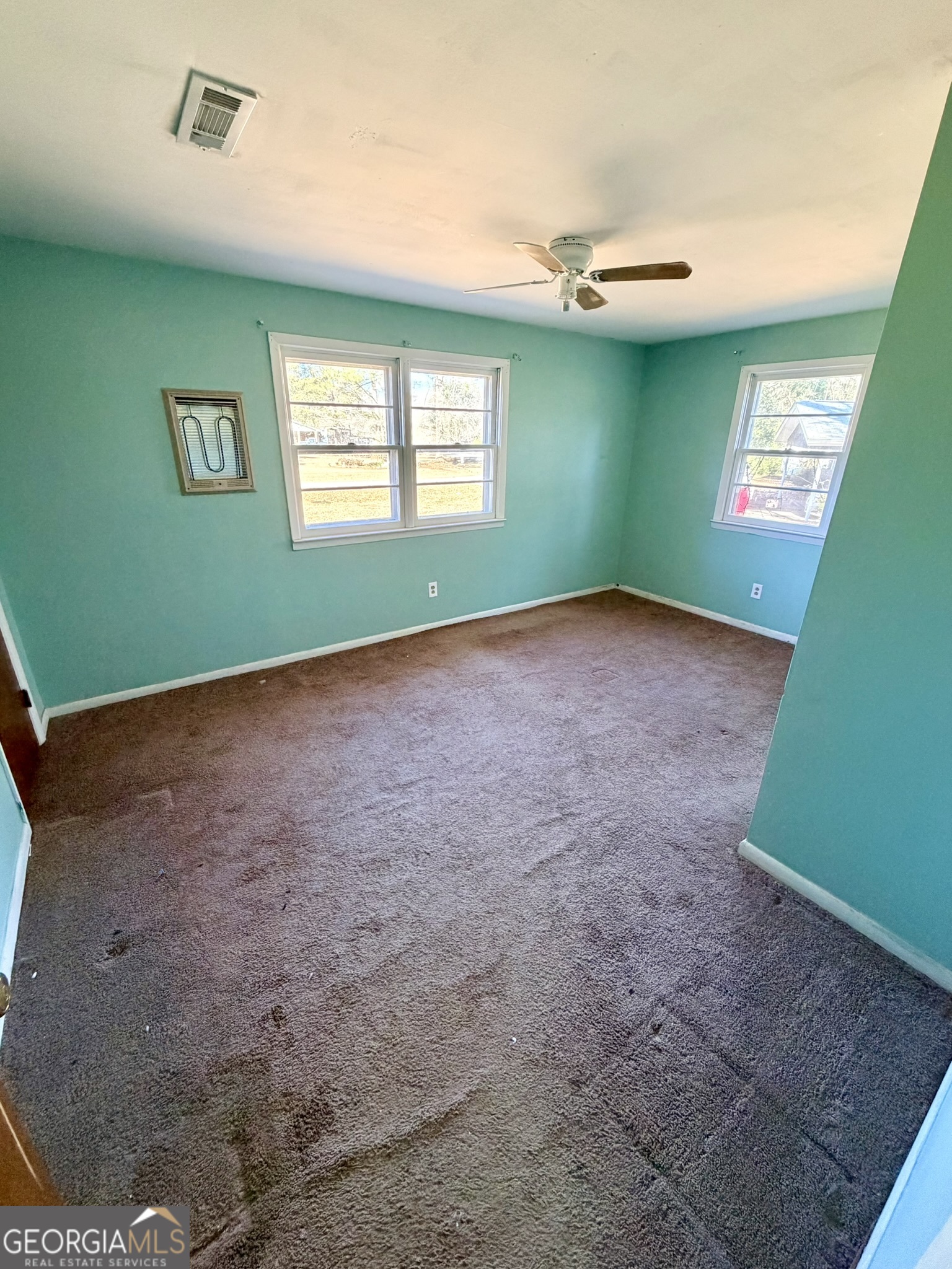 102 Lee Street Centerville, GA 31028 - Photo 11 of 30 a view of an empty room with a window and a fireplace