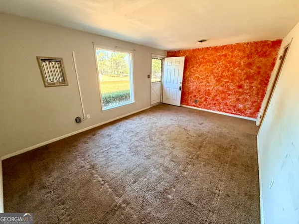 a view of an empty room with a window