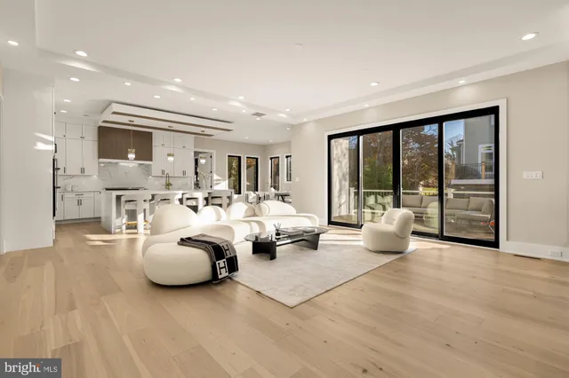a kitchen with stainless steel appliances a stove a sink and white cabinets