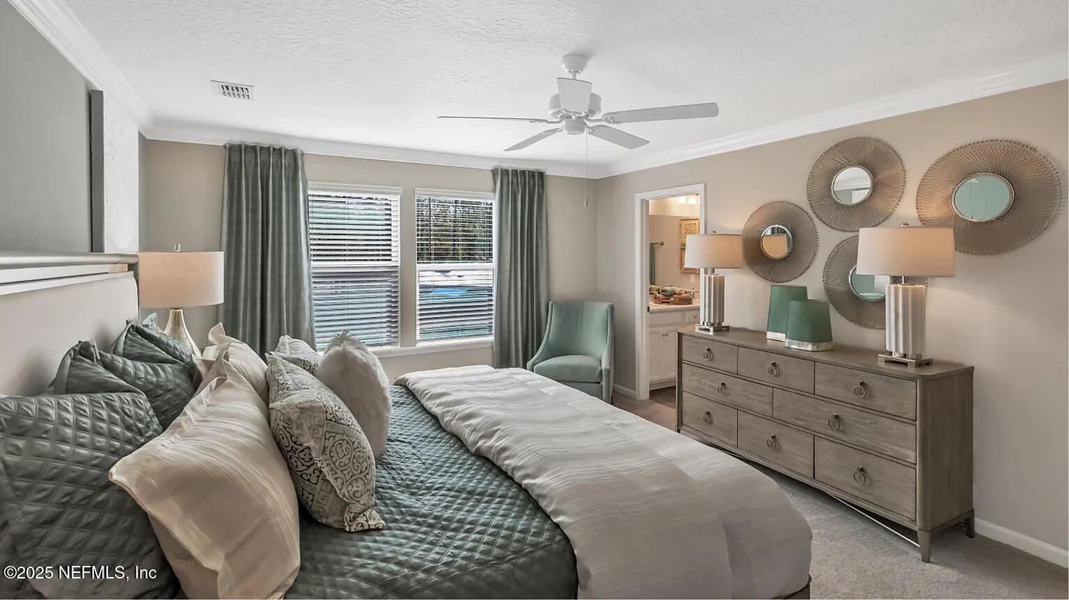 20 Carmella Court St. Augustine, FL 32092 - Photo 12 of 20 a bedroom with a bed and a chandelier