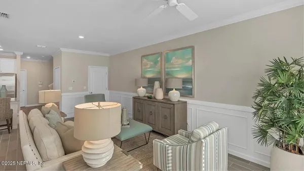 a living room with furniture a window and a potted plant