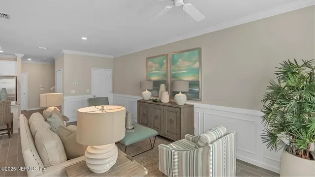 a living room with furniture a window and a potted plant