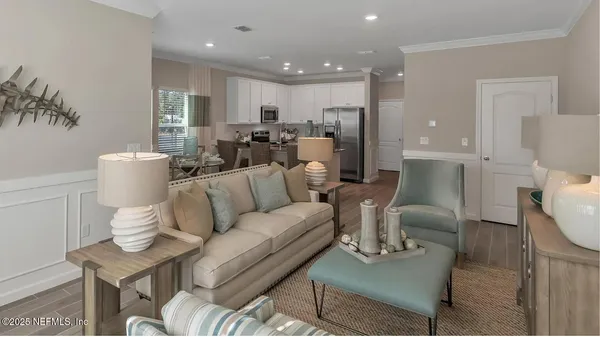 a living room with furniture and a dining table with kitchen view