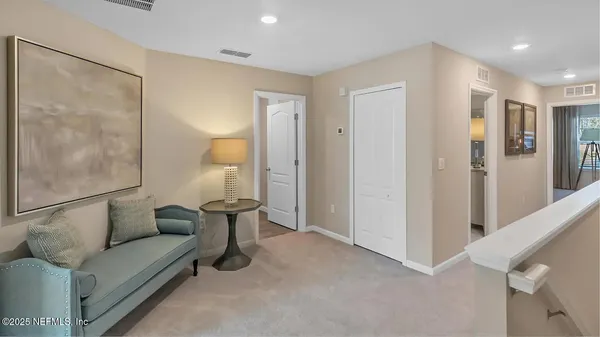 a living room with furniture and a glass door shower