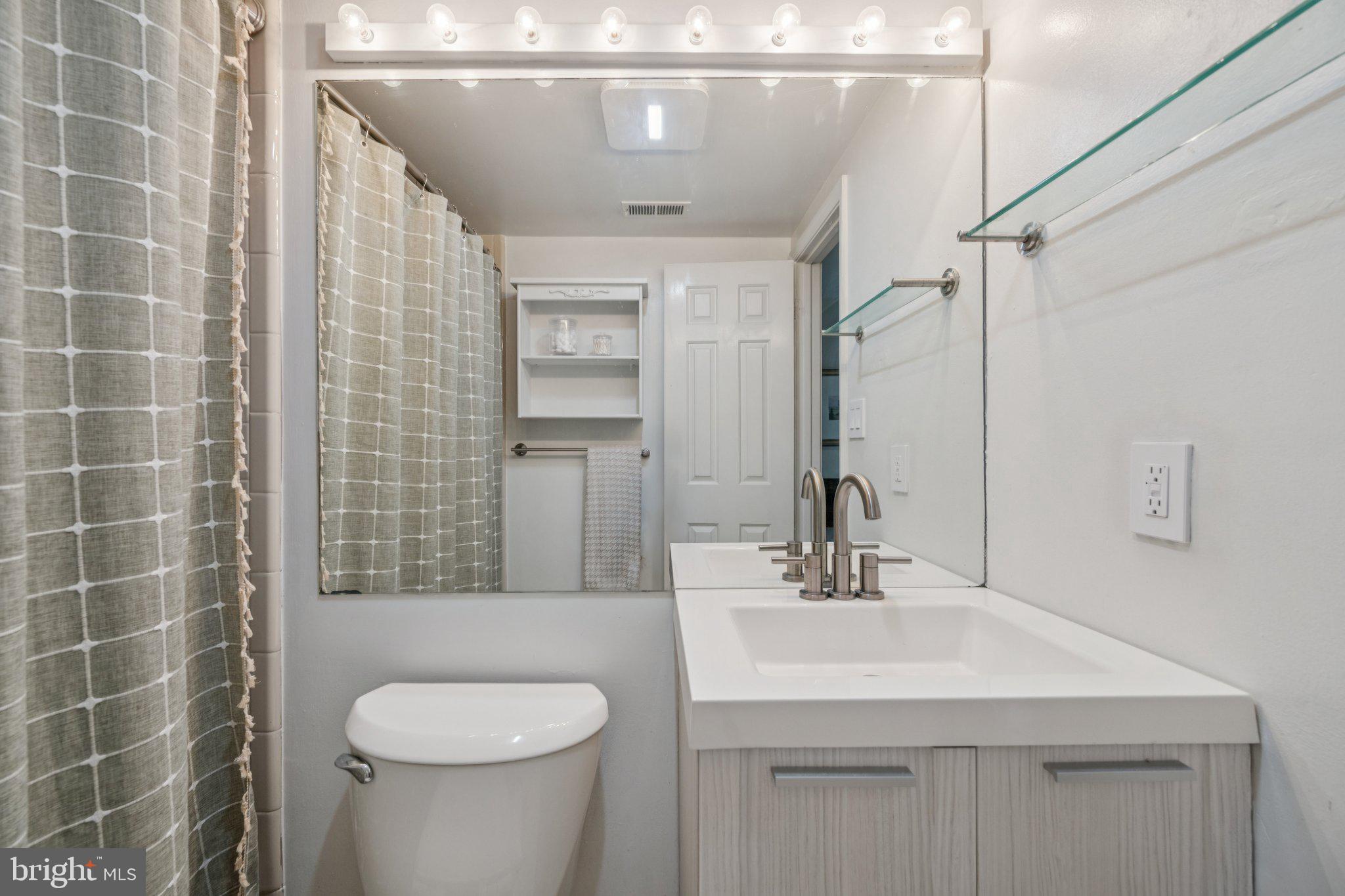 1812 Vernon Street Northwest, Unit 34 Washington, DC 20009 - Photo 21 of 26 a bathroom with a sink a toilet and shower