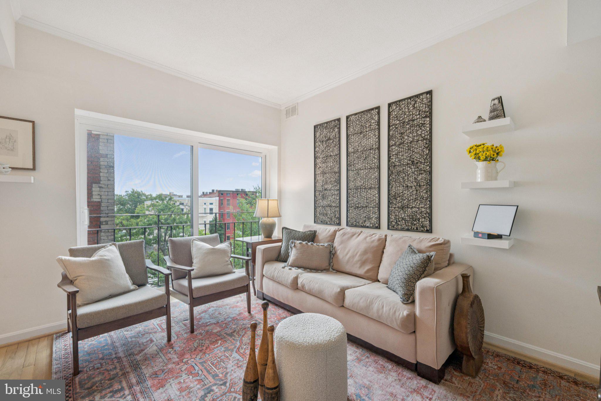 1812 Vernon Street Northwest, Unit 34 Washington, DC 20009 - Photo 4 of 26 a living room with furniture and a large window