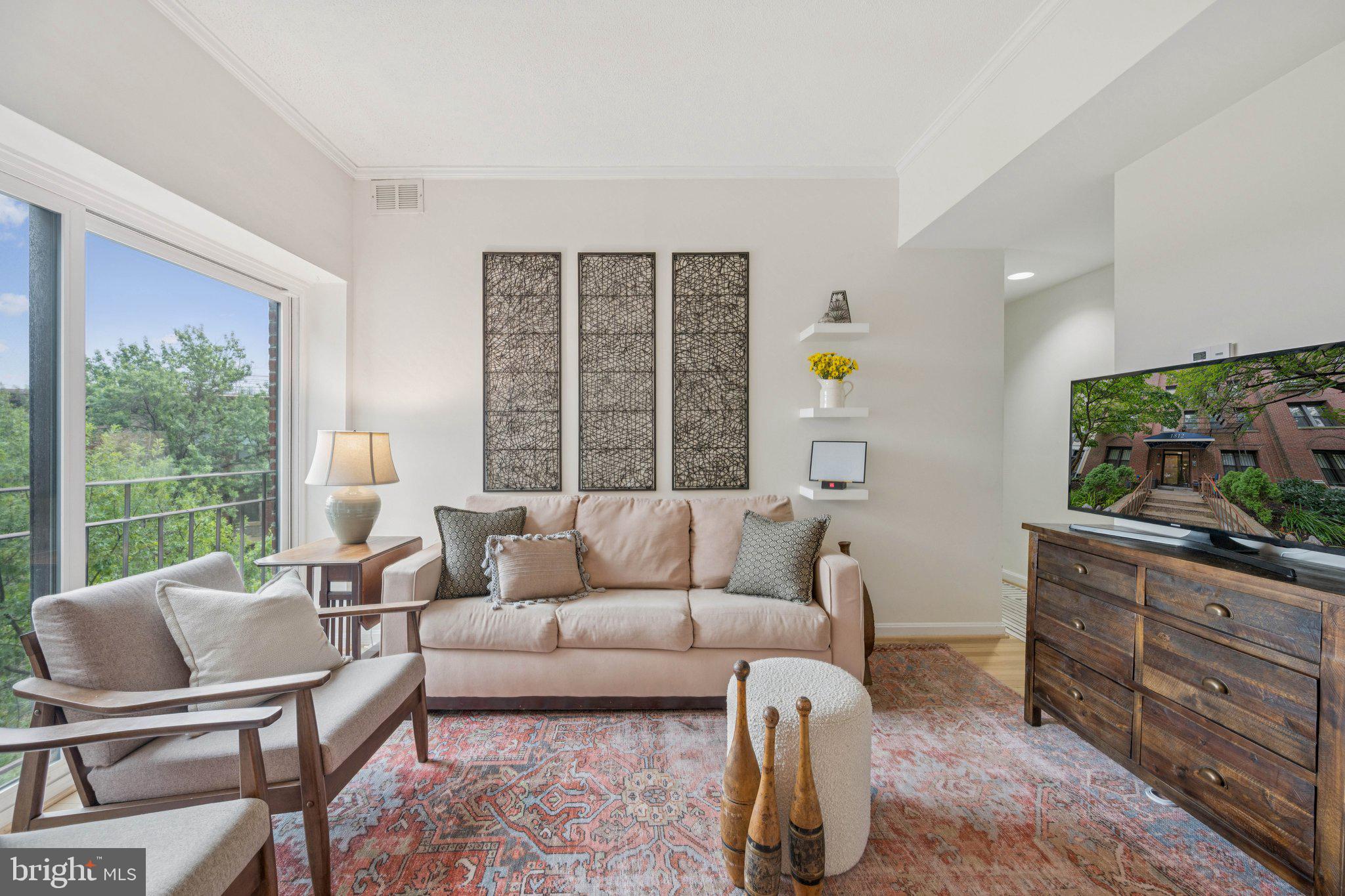 1812 Vernon Street Northwest, Unit 34 Washington, DC 20009 - Photo 5 of 26 a living room with furniture and a flat screen tv