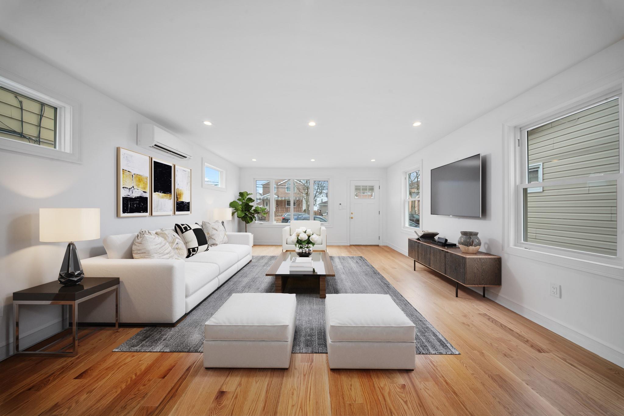 116-36 140th Street Queens, NY 11436 - Photo 1 of 1 a living room with furniture and a flat screen tv