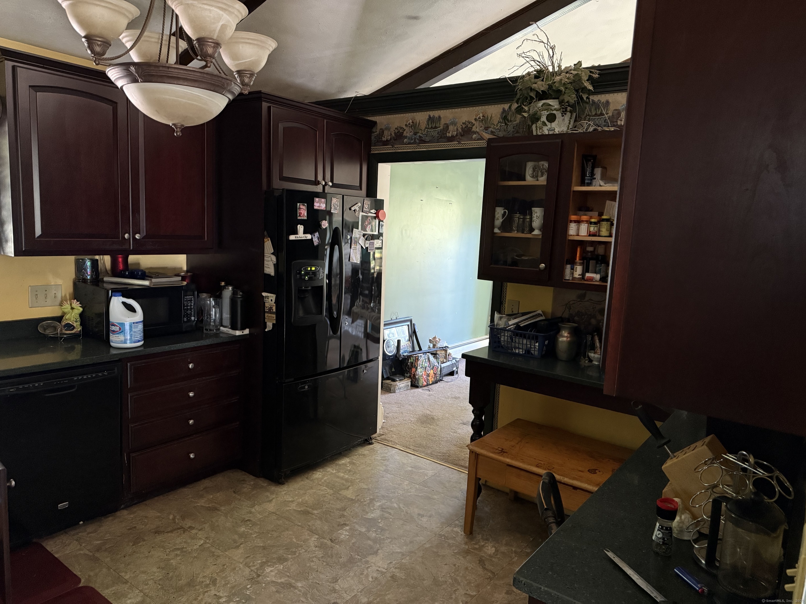 9 Deerbrook Road Norwich, CT 06360 - Photo 3 of 10 a kitchen with stainless steel appliances granite countertop a refrigerator a stove top oven a dining table and chairs with wooden floor
